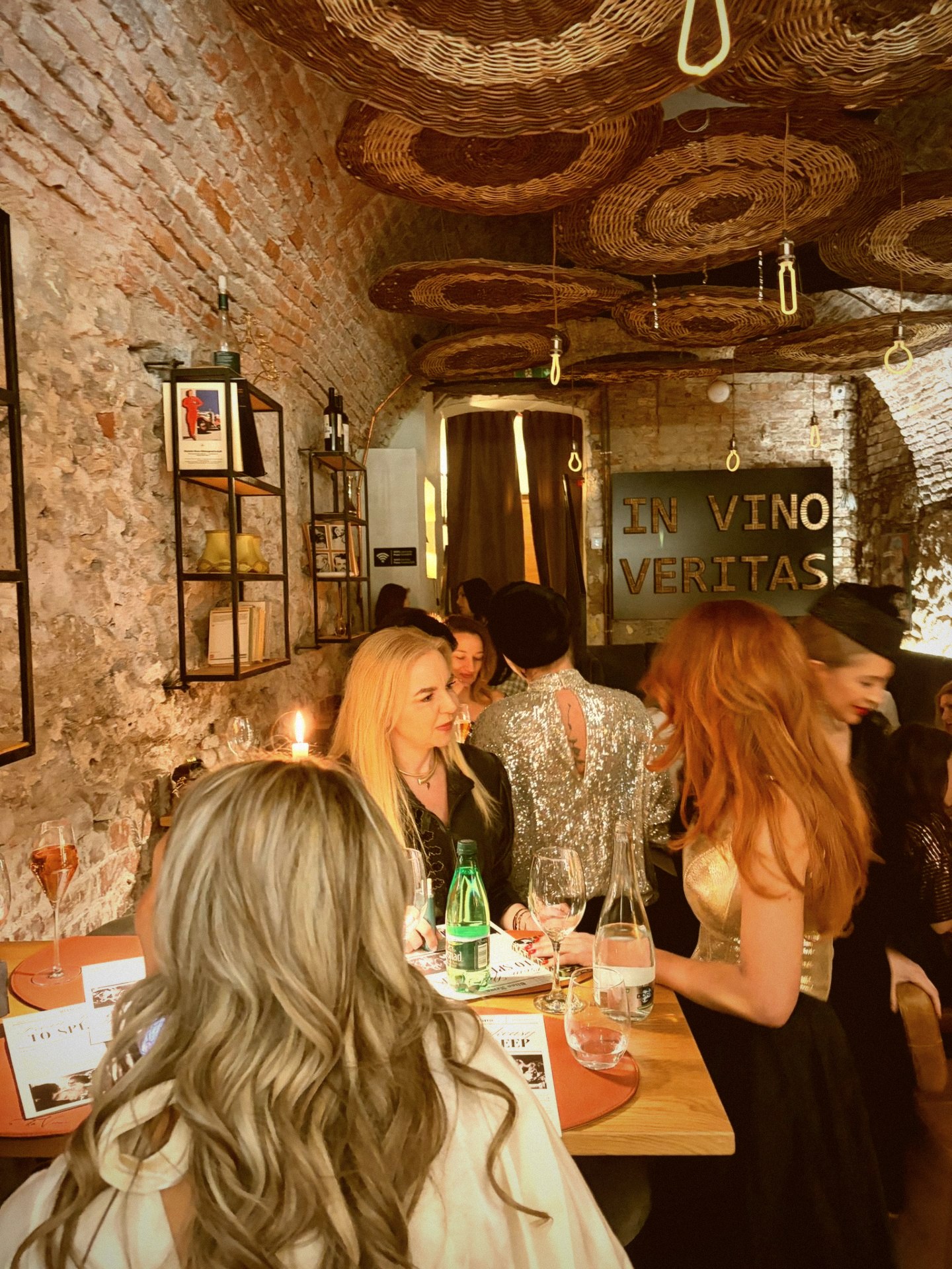 Guests in soft motion blur around a candlelit table